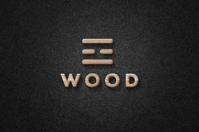 Embossed Wood Logo Mockup on Black Paper Texture