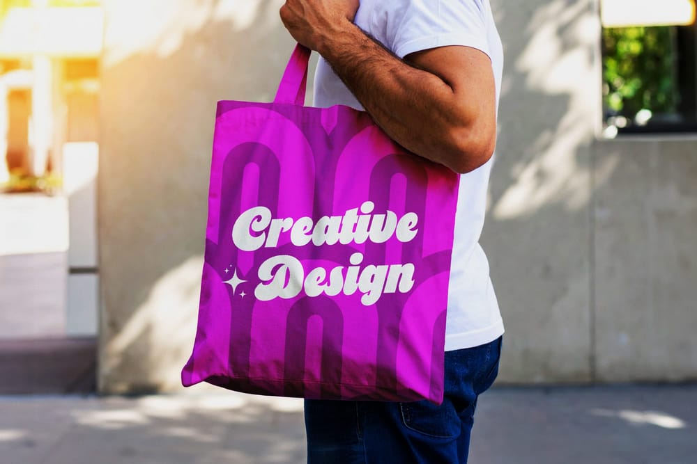 Minimalist Tote Bag Mockup Held by Man Outdoors